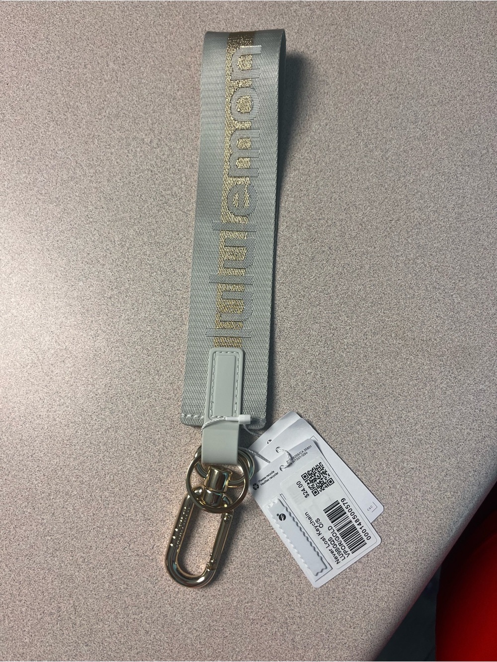 lululemon athletica gray and gold Never Lost Keychain